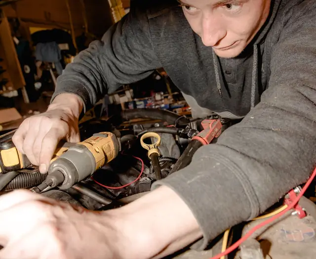 A mechanic working on an engine