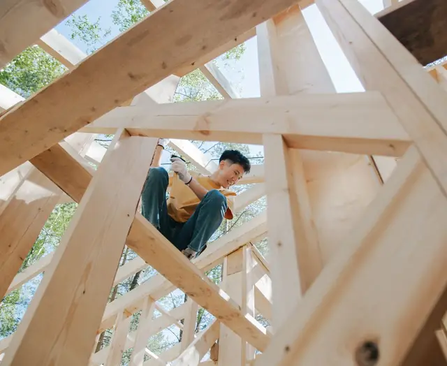 A carpenter on a timber frame