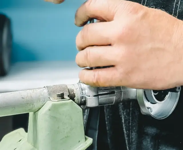 Hands tightening a pipe fitting